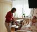 Caregiver assisting an elderly person at home