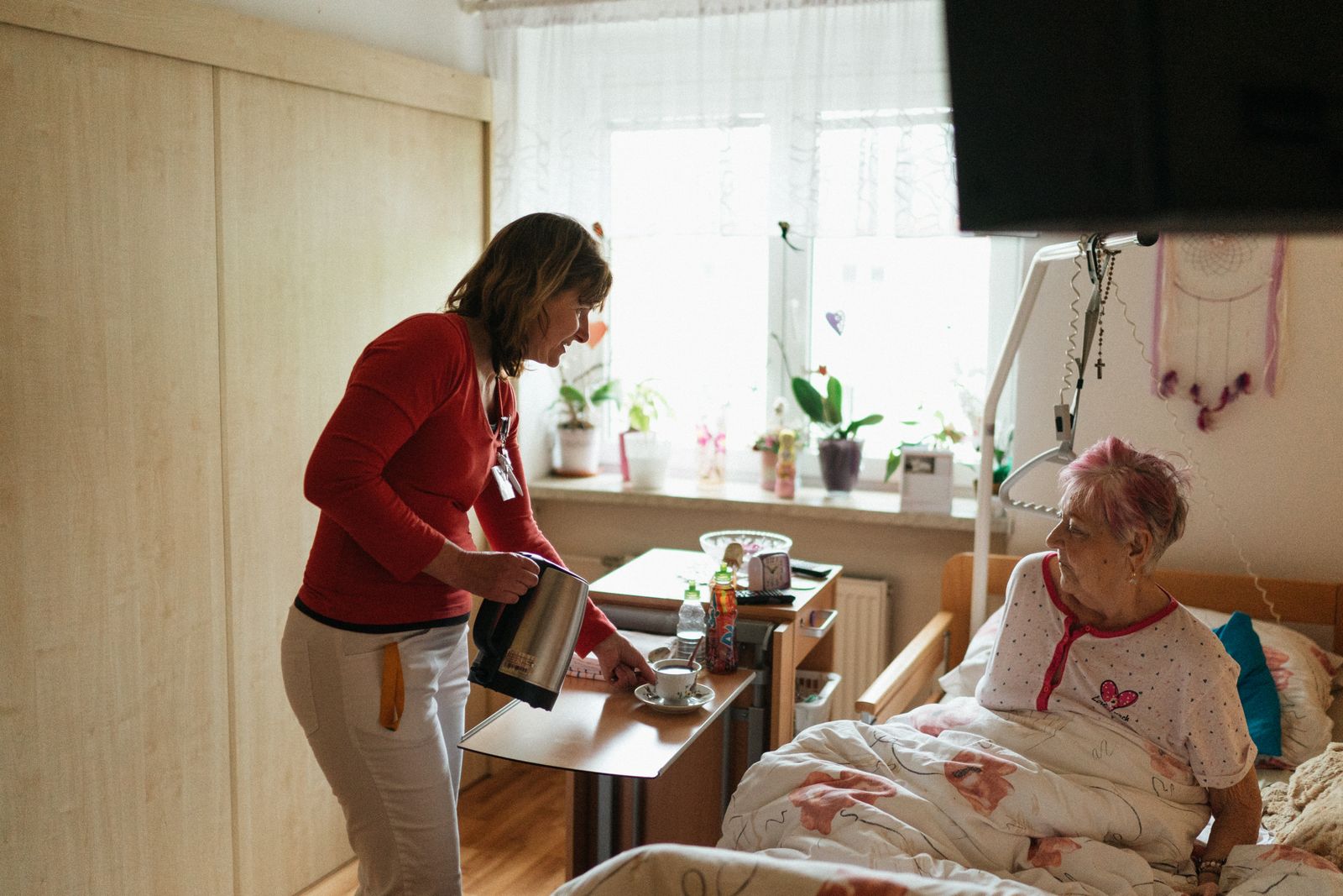 Caregiver assisting an elderly person at home